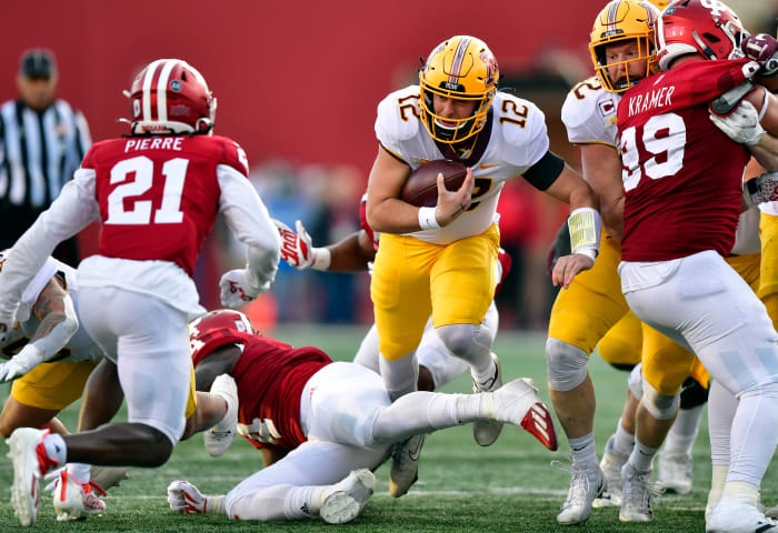 Nov 20, 2021; Bloomington, Indiana, USA; Minnesota Golden Gophers quarterback Cole Kramer (12) finds a hole in the Indiana Hoosiers during the second quarter at Memorial Stadium.